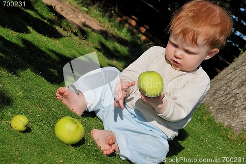 Image of baby playing with apples