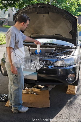 Image of Man Changing the Oil