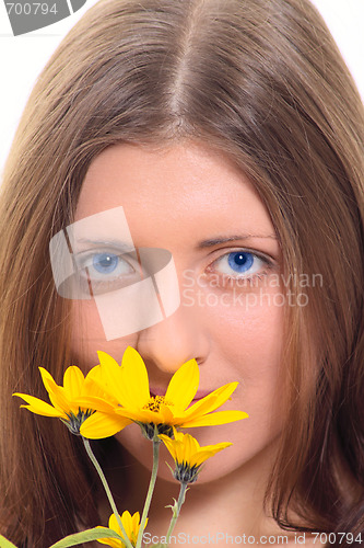 Image of The nice girl with a yellow flower