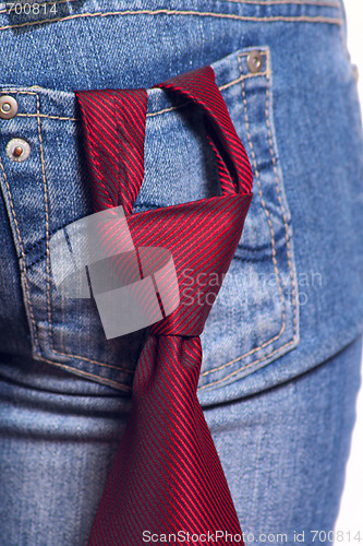 Image of Red tie in a pocket female jeans