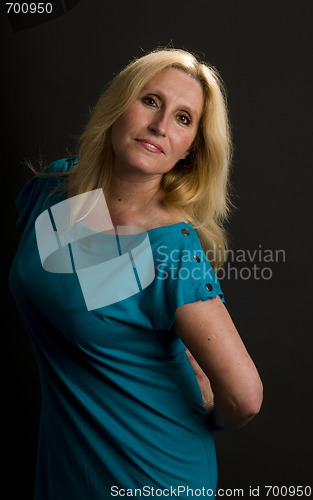 Image of glamorous woman posing in cocktail dress