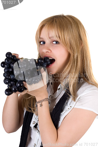 Image of Portrait of the girl eating grapes. Isolated
