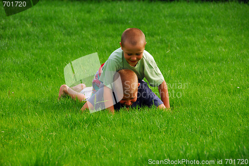 Image of boys play on the grass