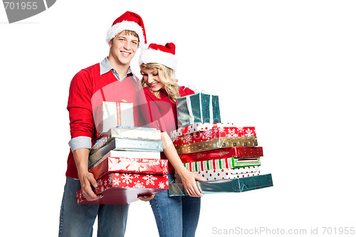 Image of Christmas shopping couple carrying gifts