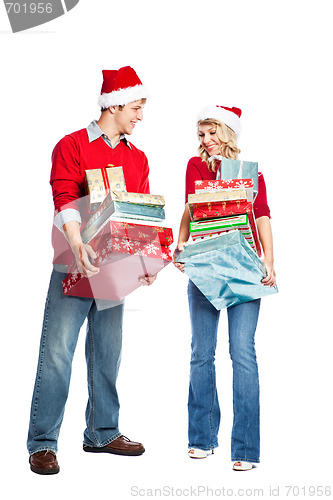 Image of Christmas shopping couple carrying gifts