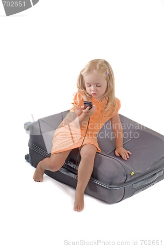 Image of Little girl and suitcase in studio