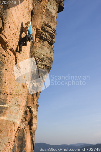 Image of Young woman climbing
