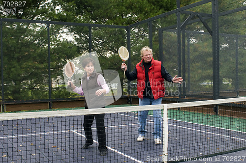 Image of man and woman playing paddle platform tennis 