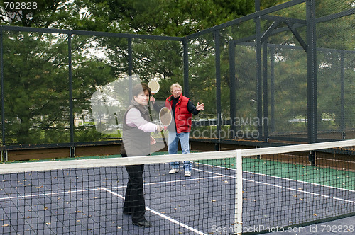 Image of man and woman playing paddle platform tennis