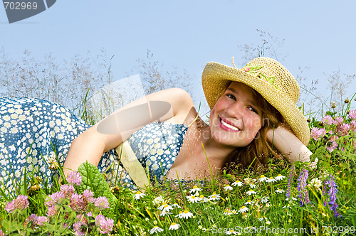 Image of Young girl laying on meadow