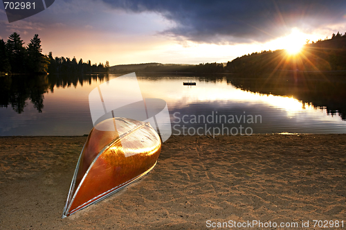 Image of Lake sunset with canoe on beach