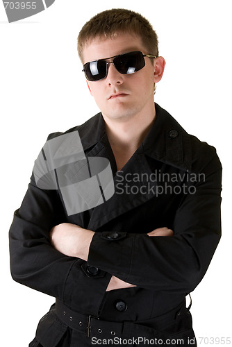 Image of man in black coat with sunglasses