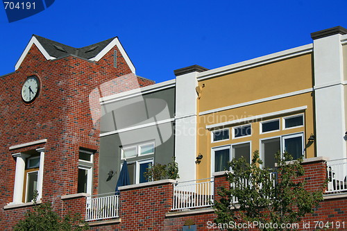 Image of Clock Tower next to Modern Buildings