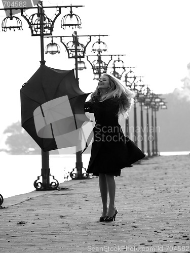 Image of Blonde with umbrella on promenade