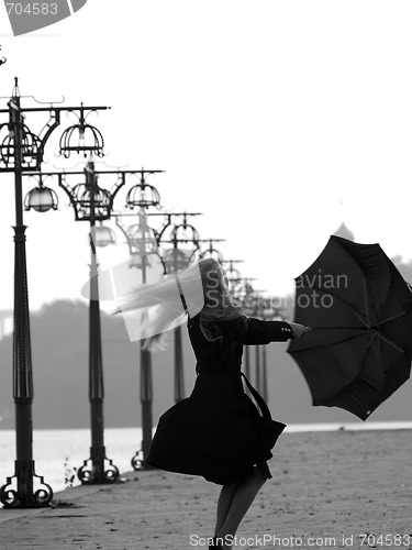 Image of Blonde with umbrella on promenade