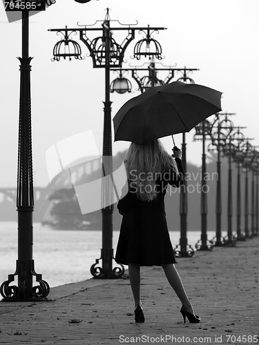Image of Blonde with umbrella on promenade