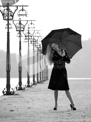 Image of Blonde with umbrella on promenade