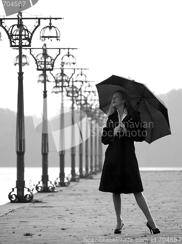 Image of Blonde with umbrella on promenade