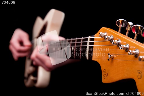 Image of Hands playing guitar string music