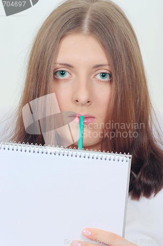 Image of Cute girl with notebook and pencil