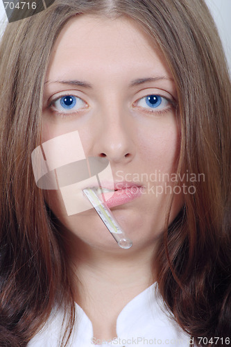 Image of The nice girl holding in a mouth a thermometer