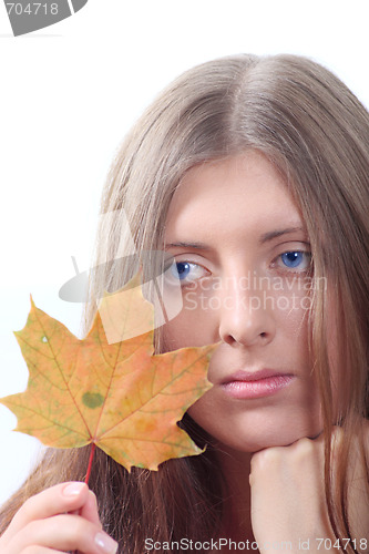 Image of The thoughtful girl with maple autumn sheet