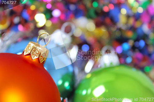 Image of New Year's fur-tree toys against a multi-coloured tinsel