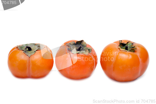 Image of Three persimmons put in row