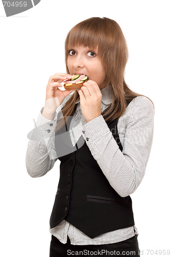 Image of Young girl eats sandwich