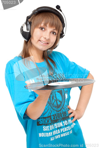 Image of Girl in earphone with vinyl disk in hand smiles