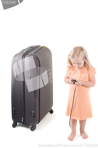 Image of Little girl and suitcase in studio