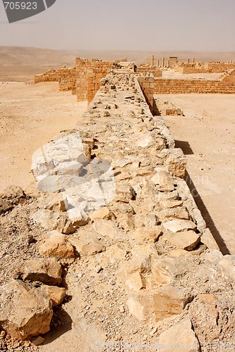 Image of Wall of the ancient fortress in the desert during sandstorm