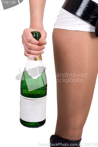 Image of Young woman with a champagne bottle. Isolated