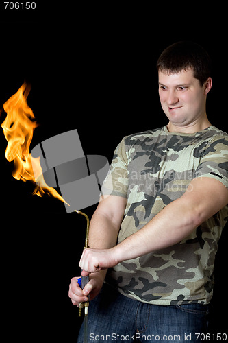 Image of Crazy young man with a gas torch