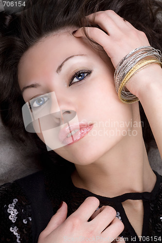 Image of Portrait of the beautiful lady lying on grey fur coat