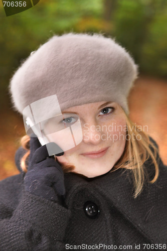 Image of Cute young woman in forest talking on cell