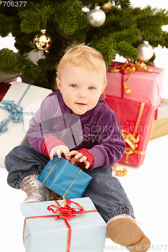 Image of Christmas - Cute child opening gifts 