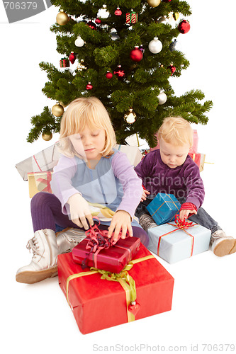 Image of Christmas - Cute young girls opening their presents