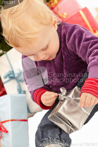 Image of Christmas Presents - Little girl opening gifts