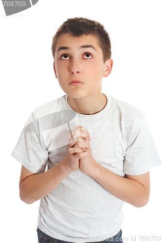 Image of Boy in prayer looks to heaven for answers