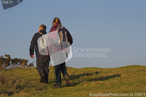 Image of A couple hiking across the countryside