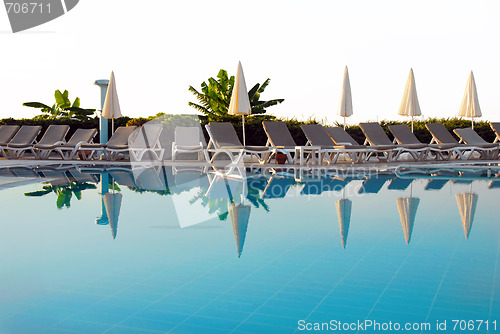 Image of Chairs by swimming pool