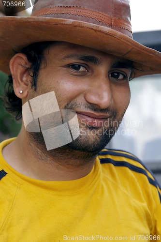 Image of Smiling Indian man with a cowboy hat