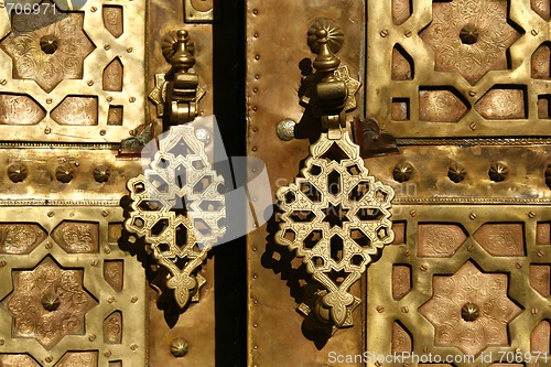 Image of Brass gate with doorknockers. Marrakech, Morocco