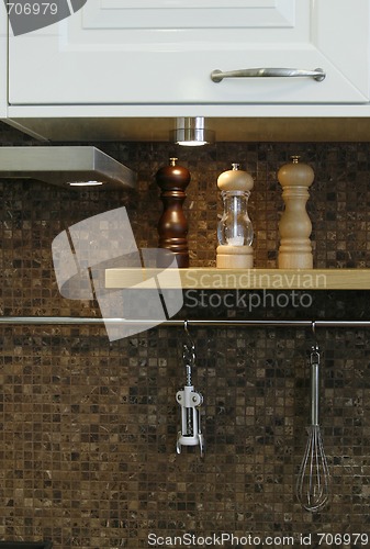 Image of Close up to a kitchen wall with utensils on it