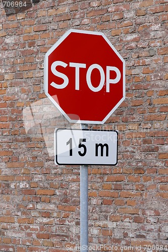 Image of Stop sign cautioning drivers to stop in 15 meters