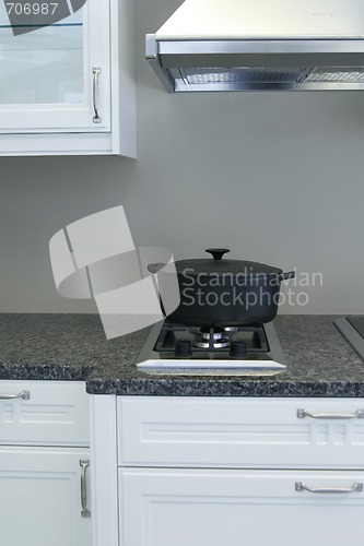 Image of A very neatly clean kitchen with a casserole pot on the stove