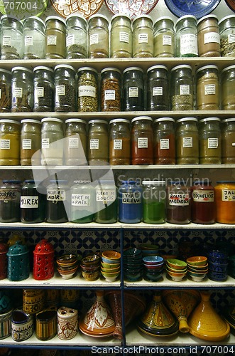 Image of Jars of herbs and powders in a moroccan spice shop.