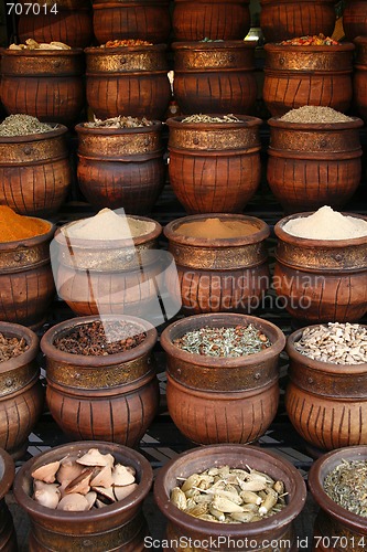 Image of Beautifully carved handmade pots full of aromatic spices on the 