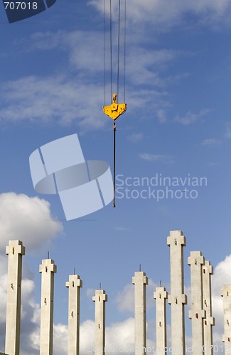 Image of Construction site with a crane hook and pillars